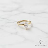 Gold Teardrop Zircon Ring flat lay op marmer met Atelier Celinéa logo